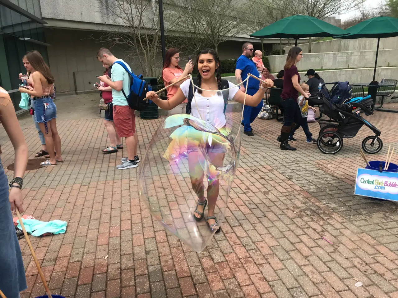 Community workshop with families making giant bubbles outdoors together