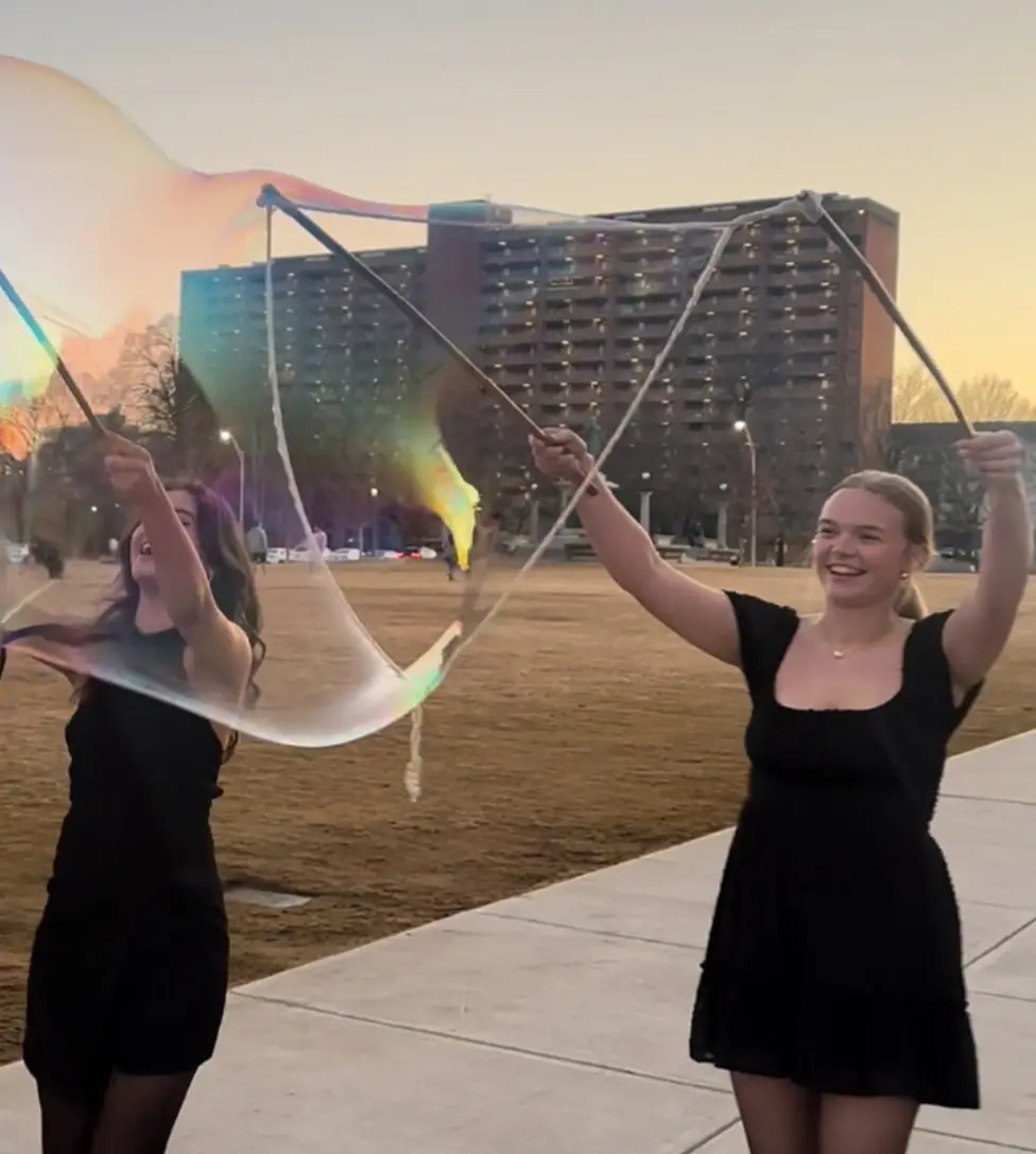 Corporate event guests enjoying giant bubble entertainment at a company party